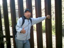 man touching border wall